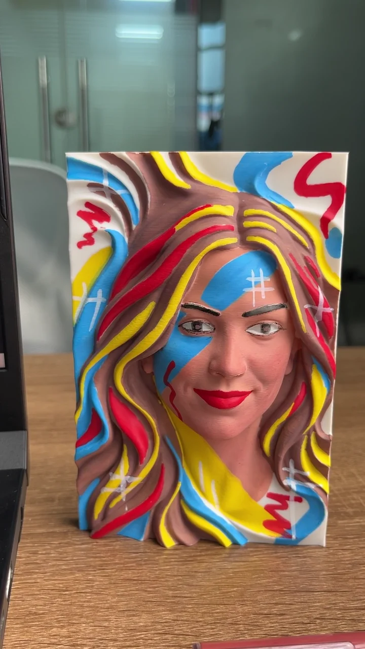 Video frame: Painting a portrait in bold primary colors.
