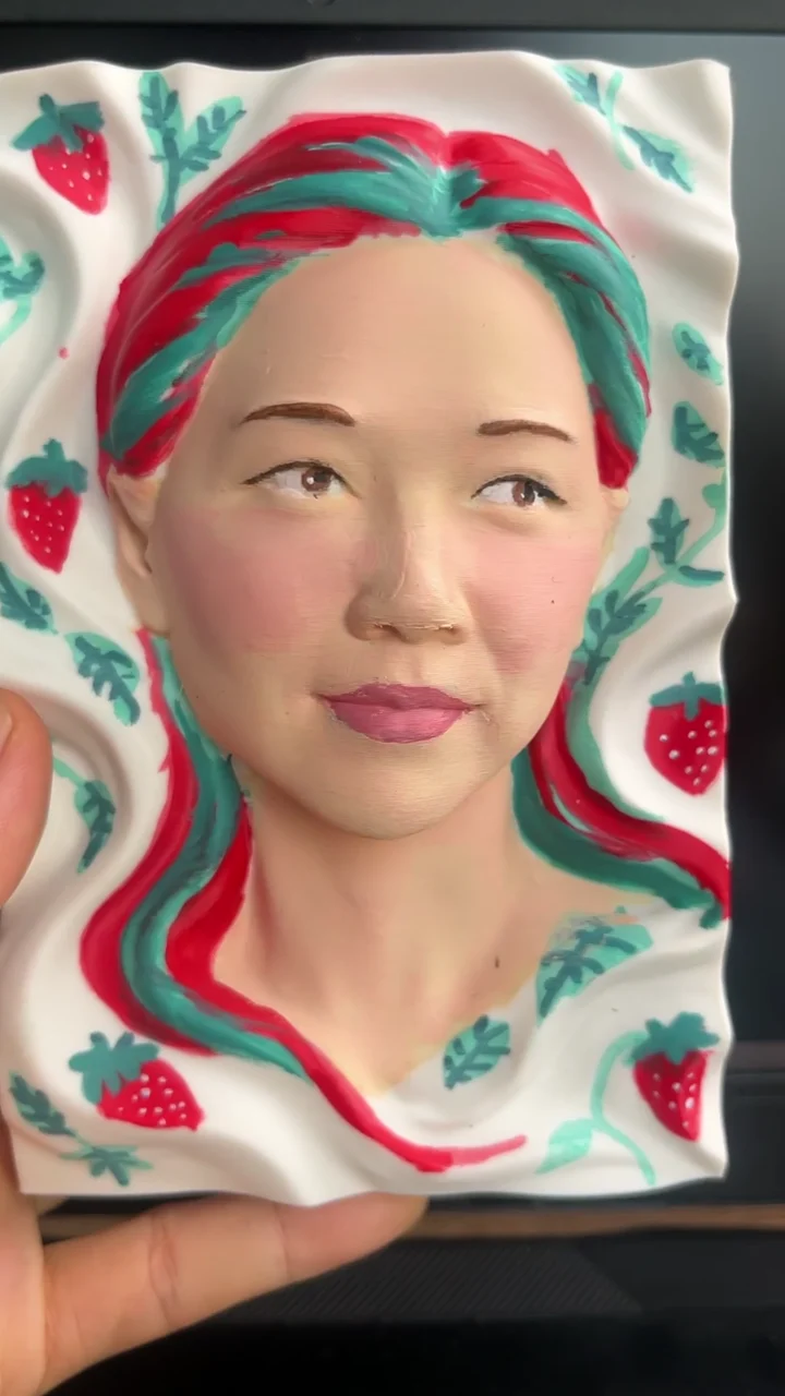 Video frame: Painting a strawberry-inspired portrait.