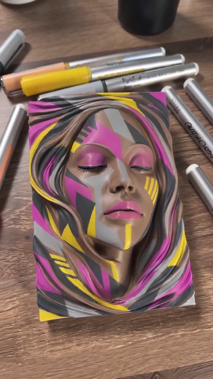 Video frame: Painting a portrait with pink and yellow accents.