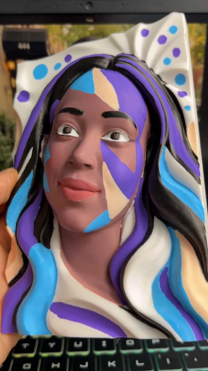 Video frame: Painting a portrait in blue and purple.