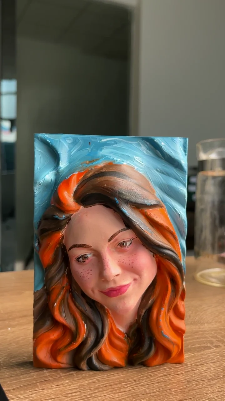 Video frame: Brush-painting a portrait with warm hair tones.